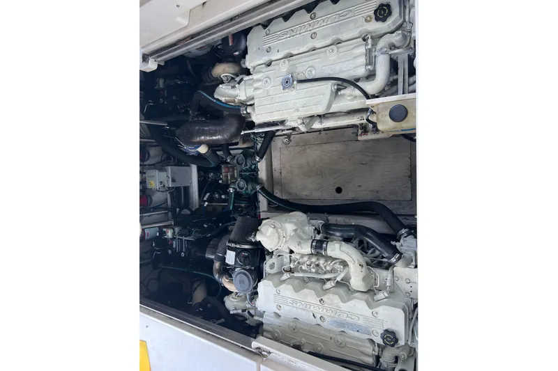 Slide: The Image of Engine compartment of a 2010 Sea Ray 450 Sundancer boat, featuring dual Cummins engines. - 22