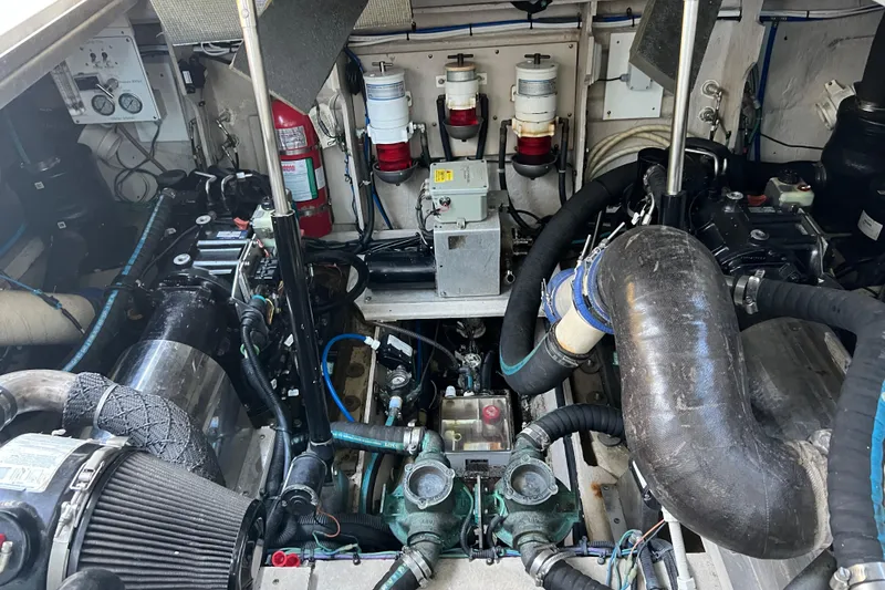 Slide: The Image of Engine room of a 2010 Sea Ray 450 Sundancer with visible components and fire extinguisher. - 23
