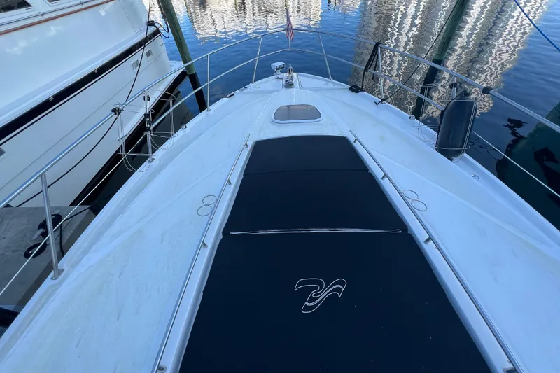 Slide: The Image of 2010 Sea Ray 450 Sundancer yacht deck with sleek design and waterfront view. - 8