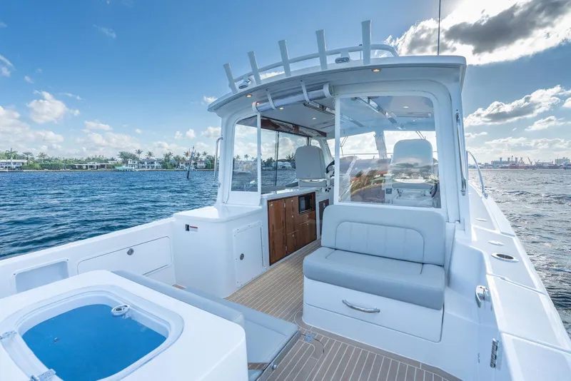 Slide: The Image of 2026 MJM 38RS boat interior with seating, ocean view, and clear skies. - 6
