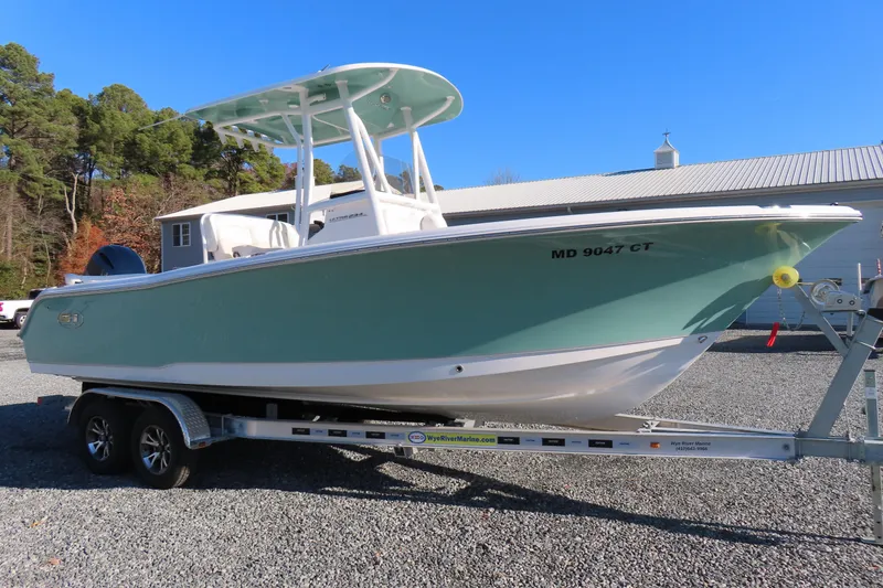 Slide: The Image of 2023 Sea Hunt Ultra 234 boat on trailer, parked outdoors. - 1