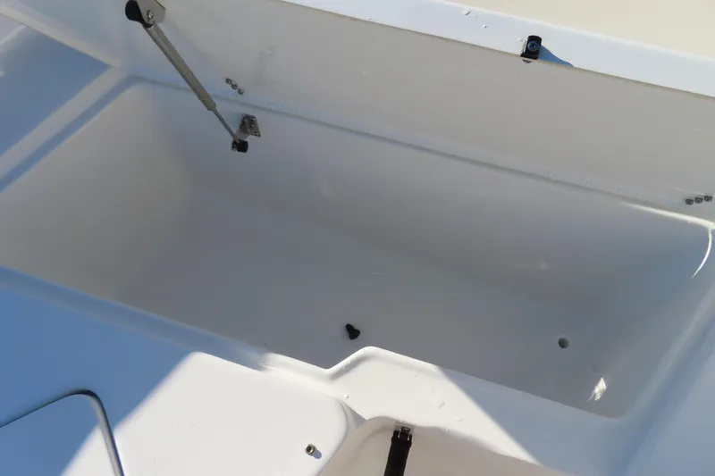 Slide: The Image of 2023 Sea Hunt Ultra 234 storage compartment, open lid, spacious interior. - 11