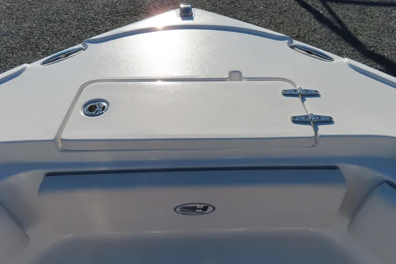 Slide: The Image of 2023 Sea Hunt Ultra 234 boat deck with storage compartment and sleek design. - 12