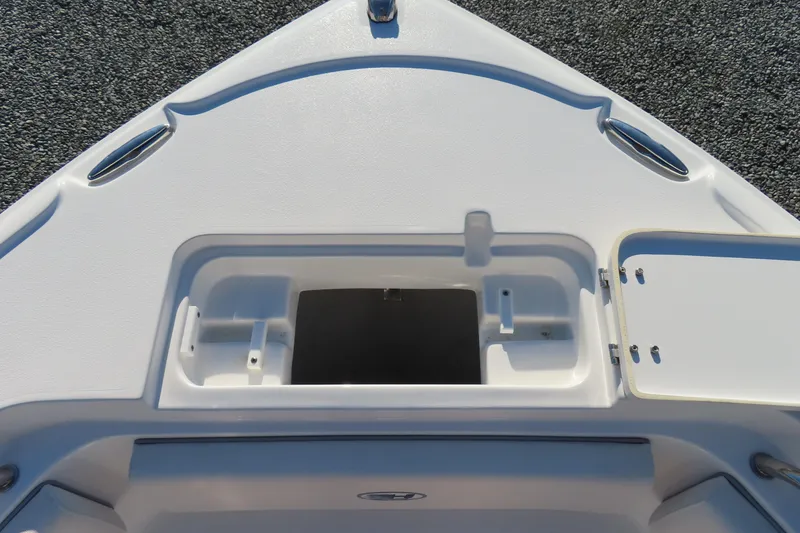 Slide: The Image of 2023 Sea Hunt Ultra 234 boat bow storage compartment, open lid, white finish. - 13