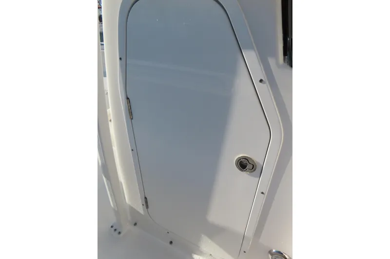 Slide: The Image of 2023 Sea Hunt Ultra 234 boat door, white exterior, close-up view. - 19