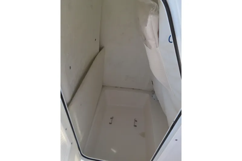 Slide: The Image of Interior compartment of 2023 Sea Hunt Ultra 234 boat, featuring a clean, white finish. - 20