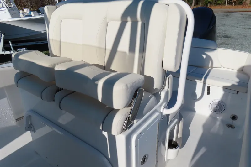 Slide: The Image of 2023 Sea Hunt Ultra 234 boat interior with cushioned seating and white railing. - 21