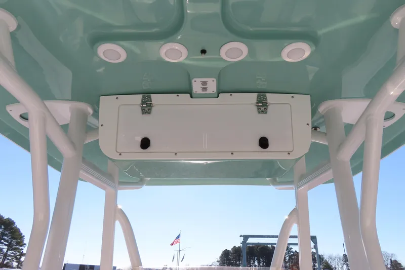 Slide: The Image of 2023 Sea Hunt Ultra 234 boat T-top with speakers and storage compartment. - 27