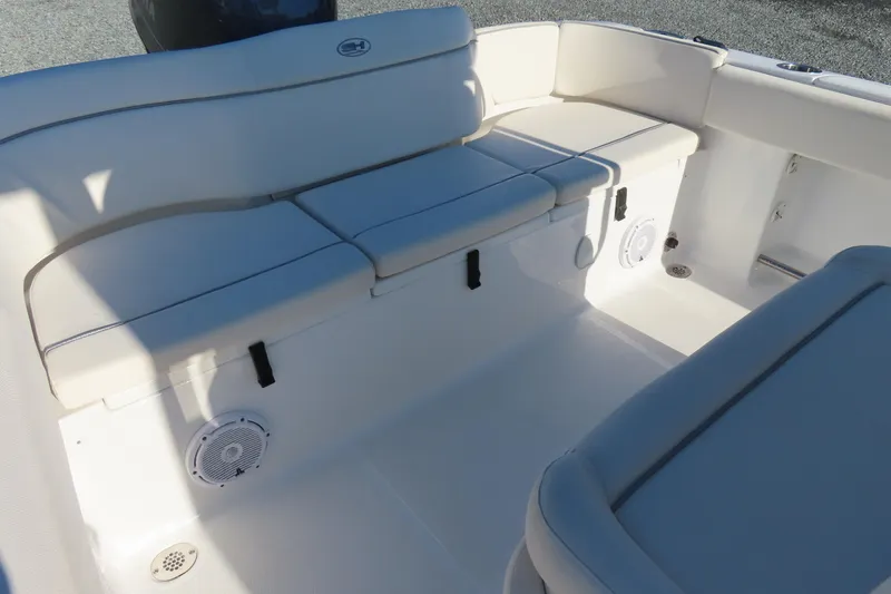 Slide: The Image of 2023 Sea Hunt Ultra 234 boat interior with cushioned seating and speakers. - 29
