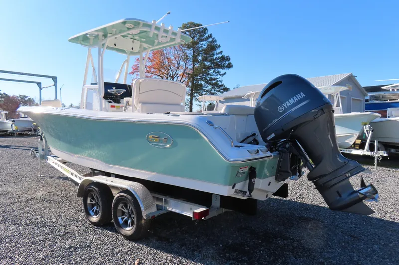 Slide: The Image of 2023 Sea Hunt Ultra 234 boat with Yamaha engine on trailer, parked outdoors. - 3