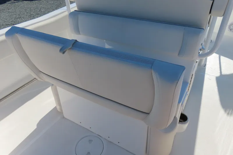Slide: The Image of 2023 Sea Hunt Ultra 234 boat seat with white upholstery and cup holder. - 31
