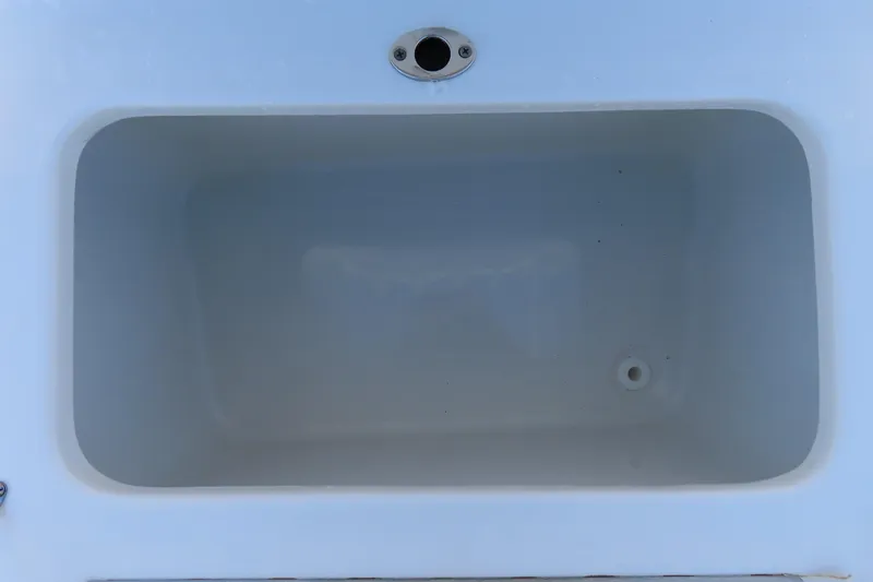 Slide: The Image of 2023 Sea Hunt Ultra 234 boat storage compartment, white interior, top view. - 32
