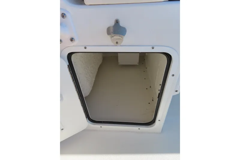 Slide: The Image of 2023 Sea Hunt Ultra 234 storage compartment with open hatch, showcasing interior space. - 34