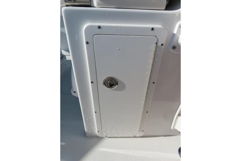 Slide: The Image of 2023 Sea Hunt Ultra 234 boat storage compartment with secure latch. - 35