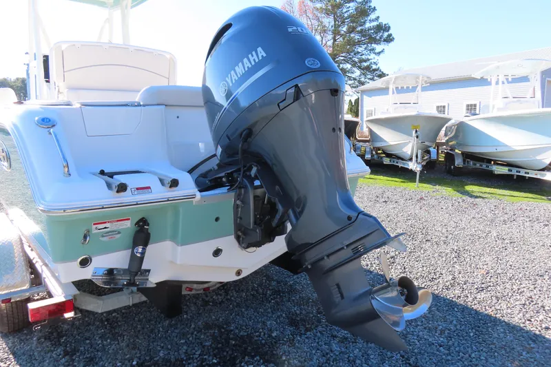 Slide: The Image of 2023 Sea Hunt Ultra 234 boat with Yamaha outboard motor, displayed outdoors. - 4