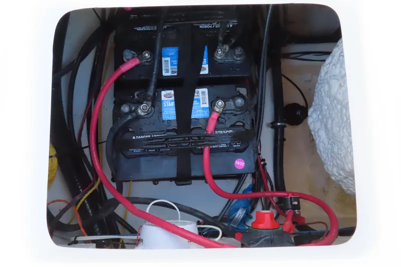 Slide: The Image of Battery compartment of 2023 Sea Hunt Ultra 234 boat with wiring and connections. - 40