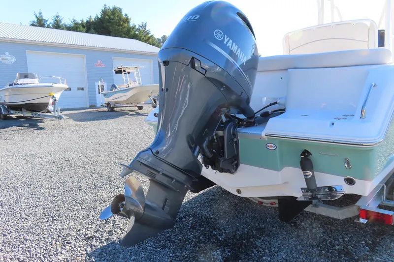 Slide: The Image of 2023 Sea Hunt Ultra 234 boat with Yamaha outboard motor in a marina setting. - 5