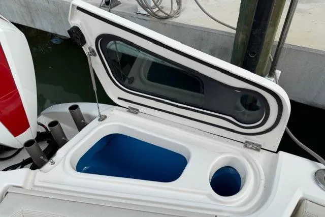 Slide: The Image of Open storage compartment on 2020 Solace 345 CC boat, featuring sleek design and functionality. - 12