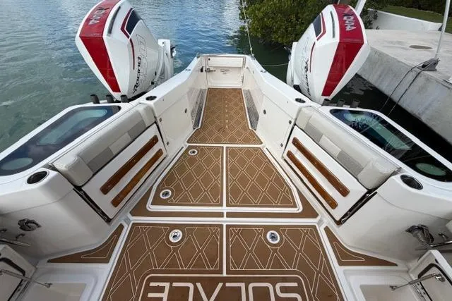 Slide: The Image of 2020 Solace 345 CC boat with twin engines, featuring spacious deck and modern design. - 14