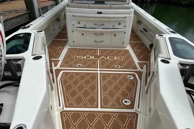 Slide: The Image of 2020 Solace 345 CC boat deck with custom flooring and storage compartments. - 15