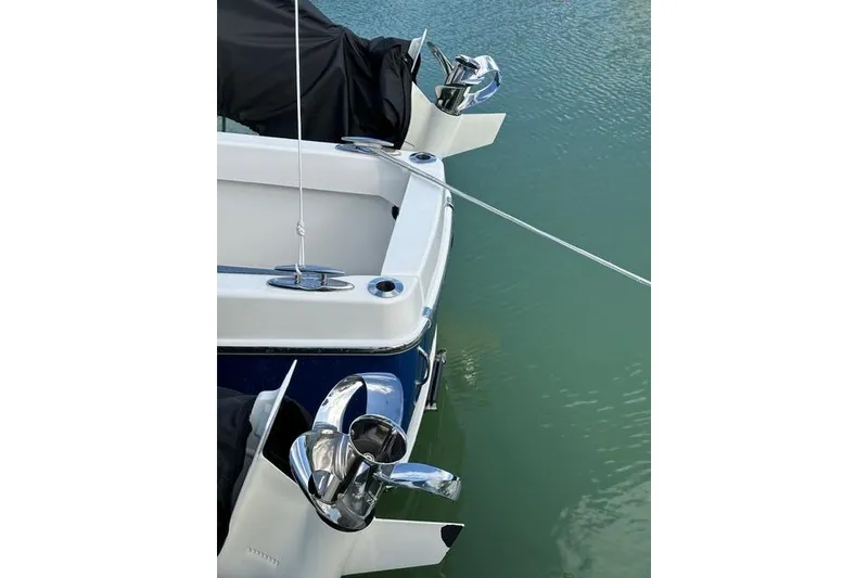 Slide: The Image of 2020 Solace 345 CC boat stern with dual outboard motors in water. - 16