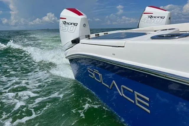 Slide: The Image of 2020 Solace 345 CC boat with twin Racing 450 engines cruising on open water. - 4