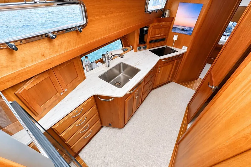 Slide: The Image of Luxurious 2013 Sabre 48 Salon Express yacht kitchen with wood cabinetry and ocean view. - 10