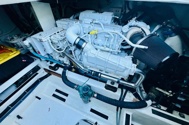 Slide: The Image of Engine compartment of a 2013 Sabre 48 Salon Express yacht, showcasing detailed machinery. - 16