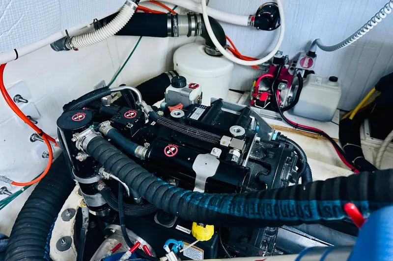 Slide: The Image of Engine room of a 2013 Sabre 48 Salon Express with visible hoses and components. - 19