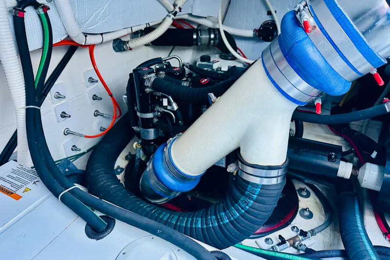Slide: The Image of Engine room of 2013 Sabre 48 Salon Express with visible hoses and components. - 21