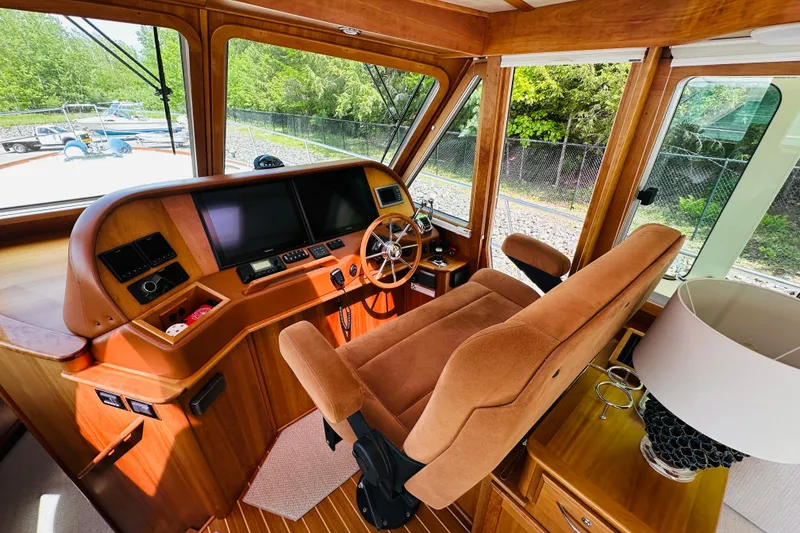 Slide: The Image of Interior helm of 2013 Sabre 48 Salon Express yacht with plush seating and navigation controls. - 4