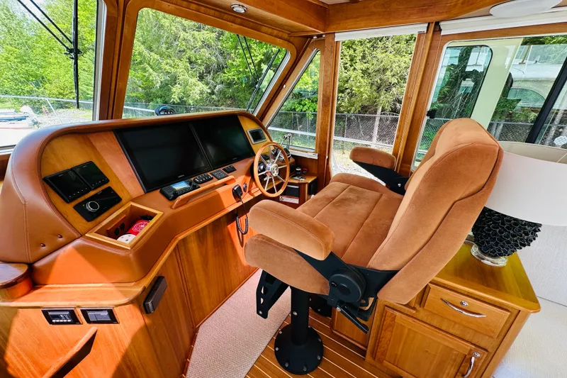 Slide: The Image of Interior helm of 2013 Sabre 48 Salon Express with plush captain's chair and navigation controls. - 6