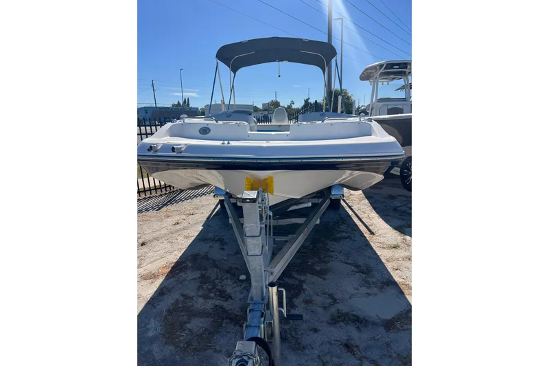 Slide: The Image of 2021 Hurricane SunDeck Sport 188 OB boat on trailer, sunny day, outdoor display. - 2