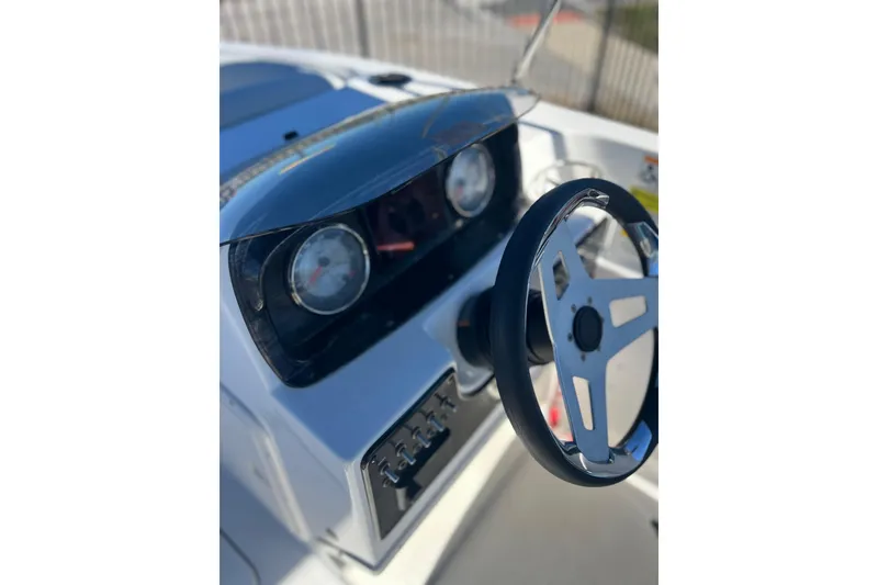 Slide: The Image of 2021 Hurricane SunDeck Sport 188 OB boat dashboard with steering wheel and gauges. - 5