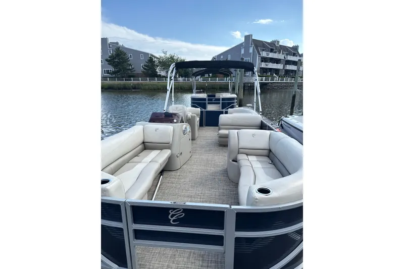 Slide: The Image of 2023 Cypress Cay Seabreeze 232 pontoon boat with spacious seating on a calm waterway. - 3