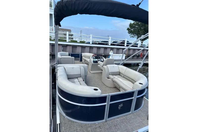 Slide: The Image of 2023 Cypress Cay Seabreeze 232 pontoon boat with spacious seating at dock. - 4