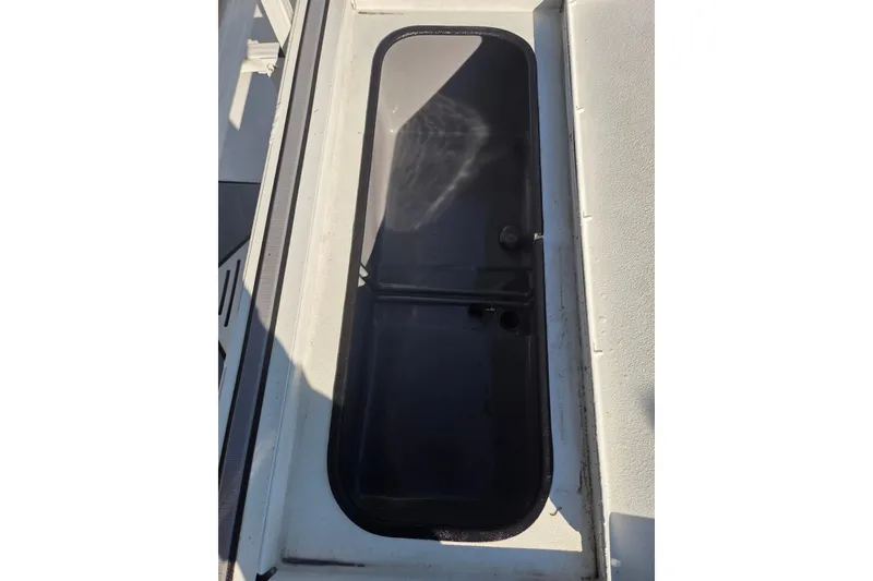Slide: The Image of 2020 Crestliner 2000 Bay boat hatch, featuring a sleek black cover. - 11