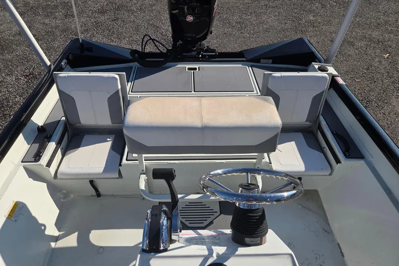 Slide: The Image of 2020 Crestliner 2000 Bay boat interior with seating and steering wheel. - 14