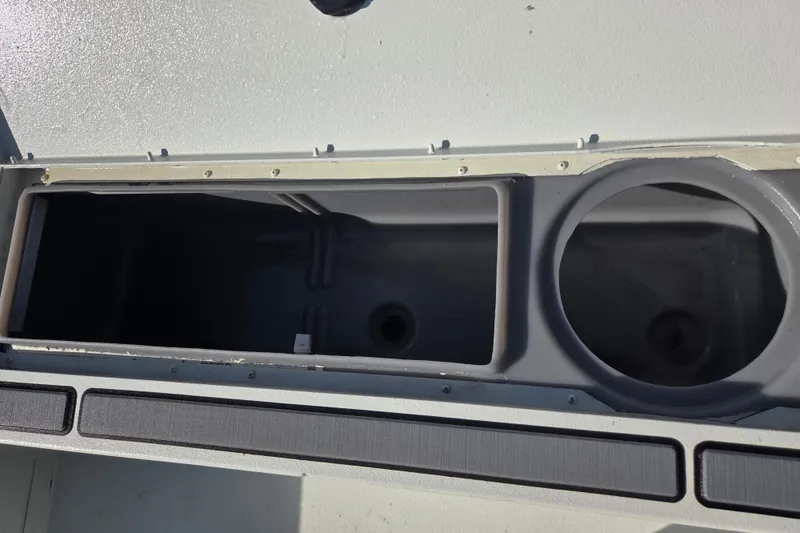 Slide: The Image of 2020 Crestliner 2000 Bay boat storage compartments, open and empty, with visible interior details. - 15