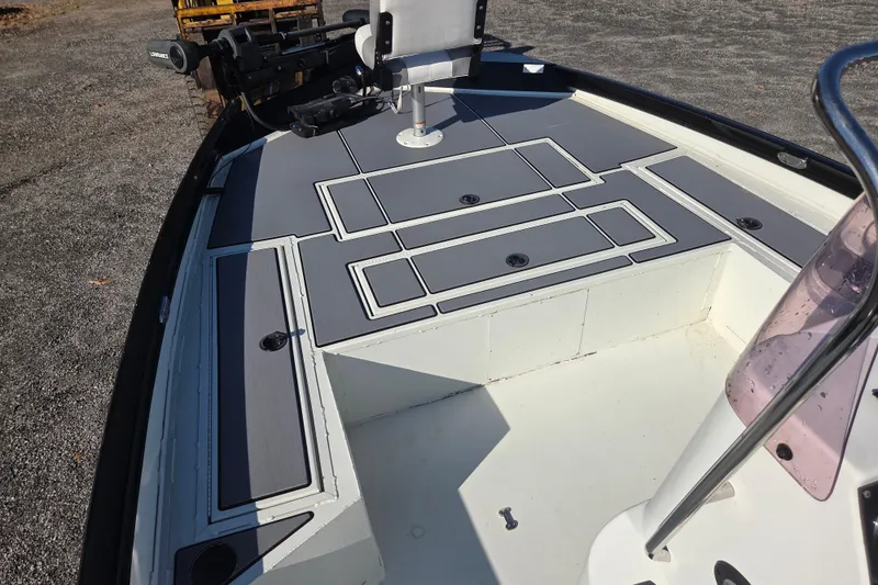 Slide: The Image of 2020 Crestliner 2000 Bay boat deck with storage compartments and fishing equipment. - 7