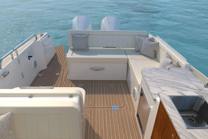 Slide: The Image of Luxurious 2026 MJM 38R yacht deck with seating, cushions, and kitchenette on calm blue water. - 3