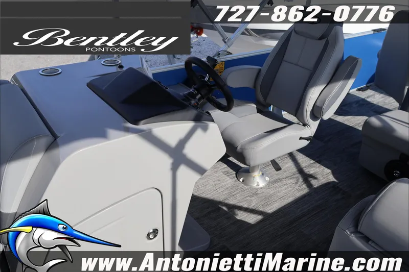 Slide: The Image of 2026 Bentley Pontoons 243 Fish-N-Cruise interior with steering console and seating. - 18