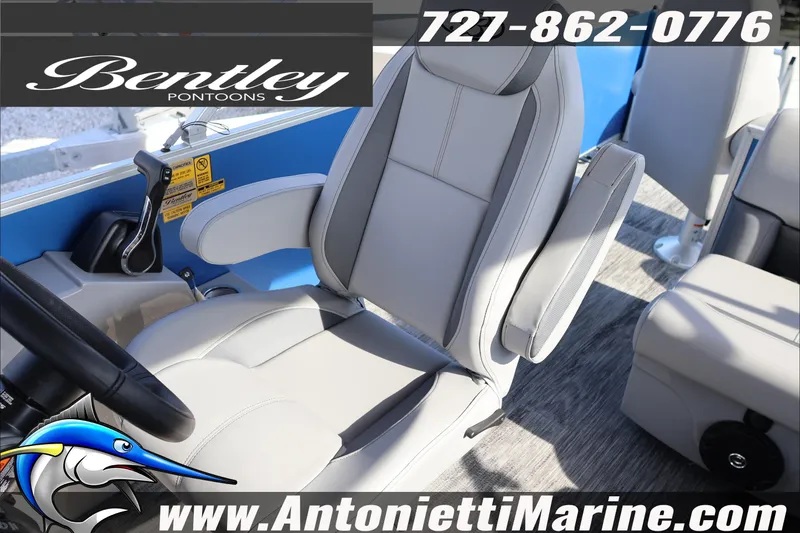 Slide: The Image of 2026 Bentley Pontoons 243 Fish-N-Cruise boat interior with comfortable seating and controls. - 19