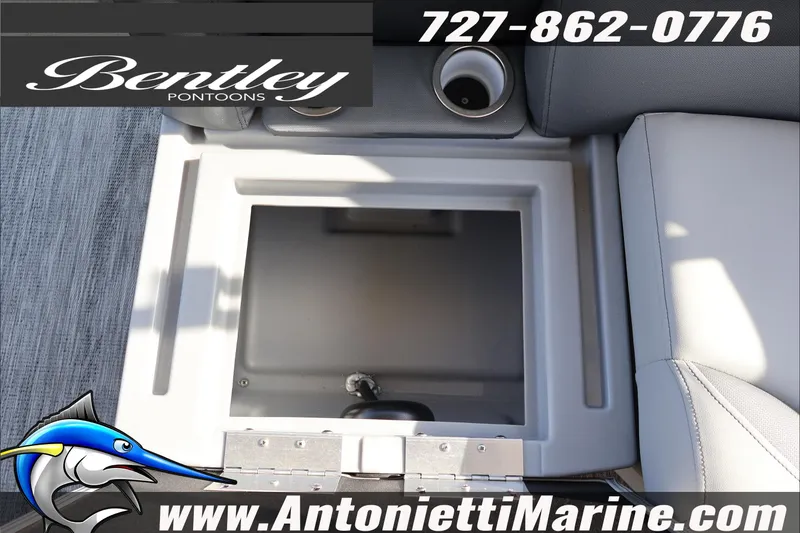 Slide: The Image of 2026 Bentley Pontoons 243 Fish-N-Cruise interior storage compartment, featuring cup holder and seating. - 41