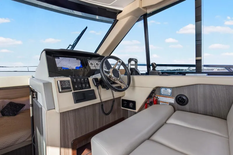 Slide: The Image of Helm of 2020 Regal 38 XO yacht with modern navigation system and comfortable seating. - 15