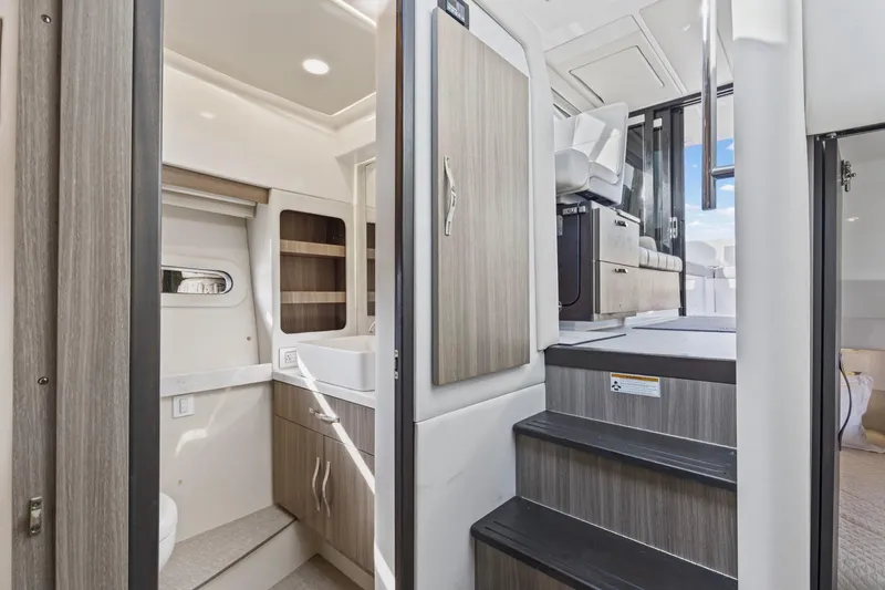 Slide: The Image of 2020 Regal 38 XO yacht interior with modern bathroom and stairs to upper deck. - 21