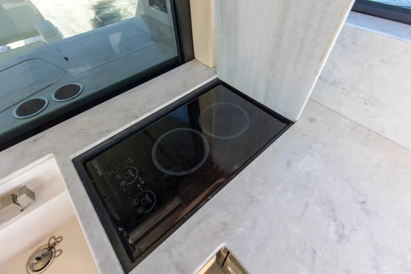 Slide: The Image of Modern stovetop on 2020 Regal 38 XO yacht with sleek countertop design. - 29