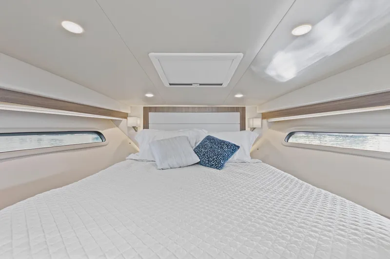 Slide: The Image of Luxurious cabin interior of 2020 Regal 38 XO yacht with cozy bedding. - 31