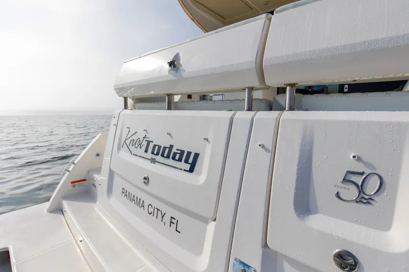 Slide: The Image of 2020 Regal 38 XO boat with "Knot Today" name, Panama City, FL, on calm water. - 38