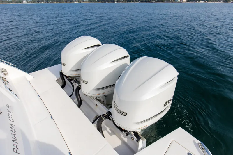 Slide: The Image of 2020 Regal 38 XO boat with triple Yamaha outboard engines on open water. - 39